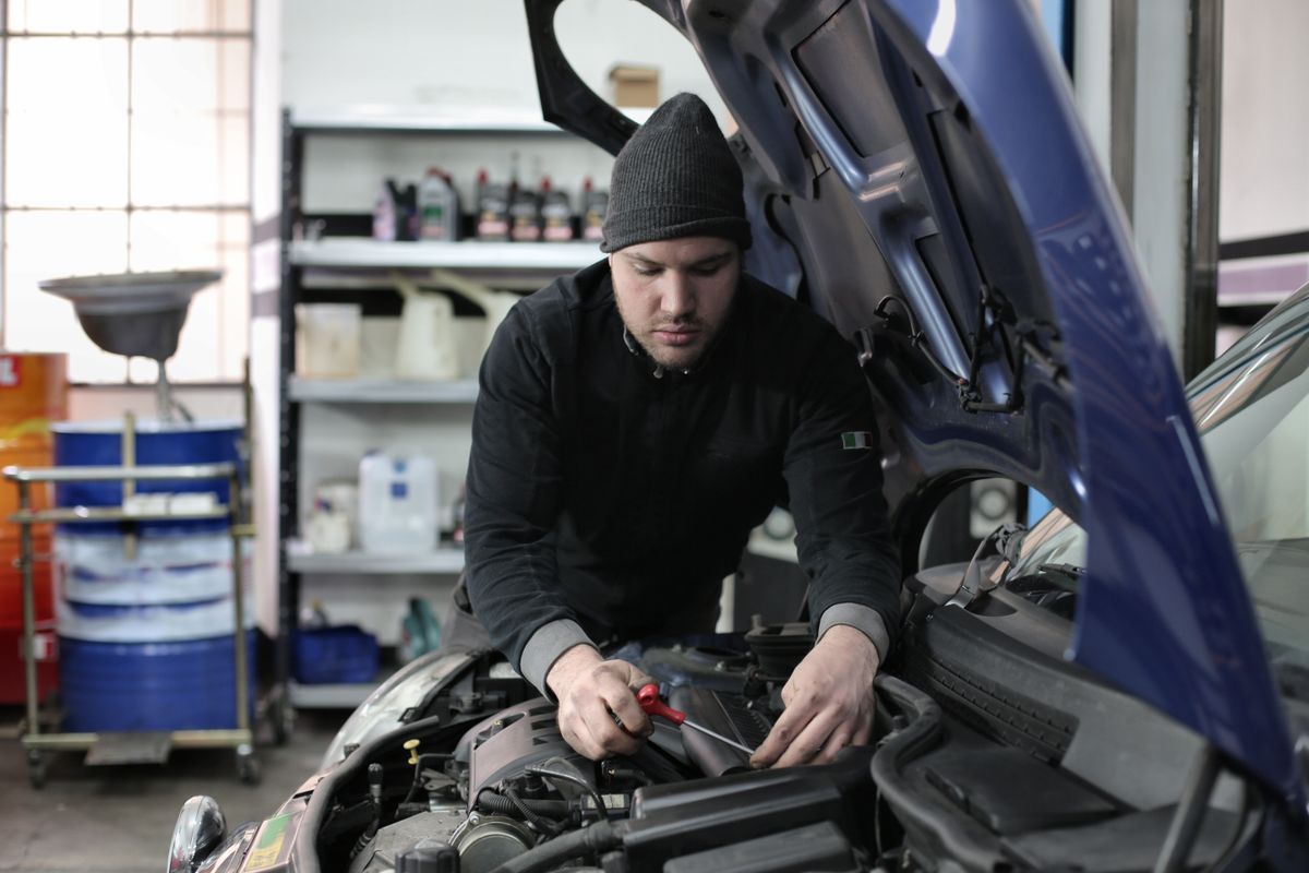 Car interior maintenance work near the dashboard and glove-box area